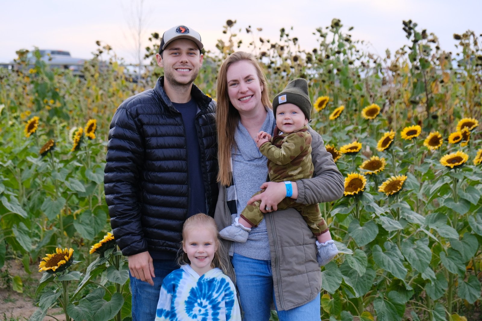 Alex and family in a sunflower field